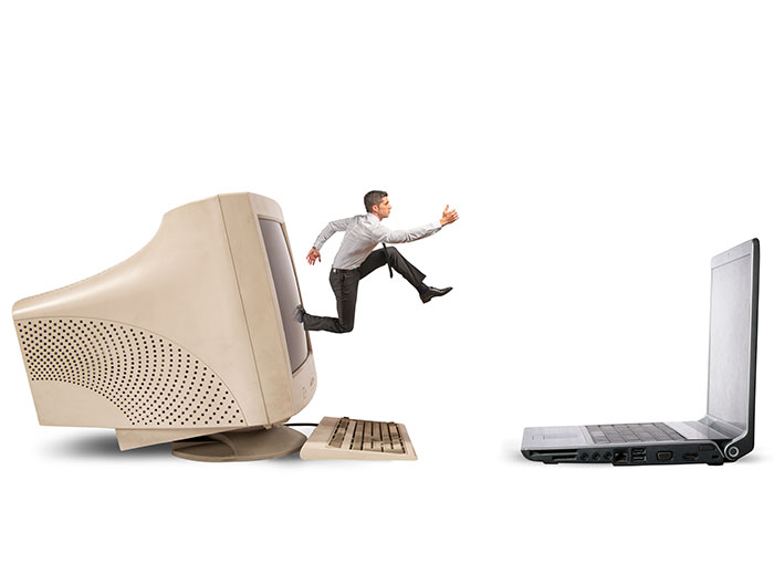 Man jumping from old to new computer